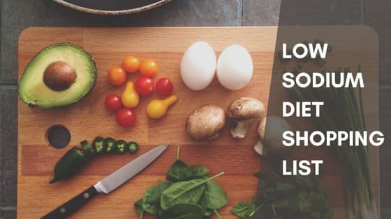 Fruits and vegetables on a cutting board with text: Low Sodium Diet Shopping List.